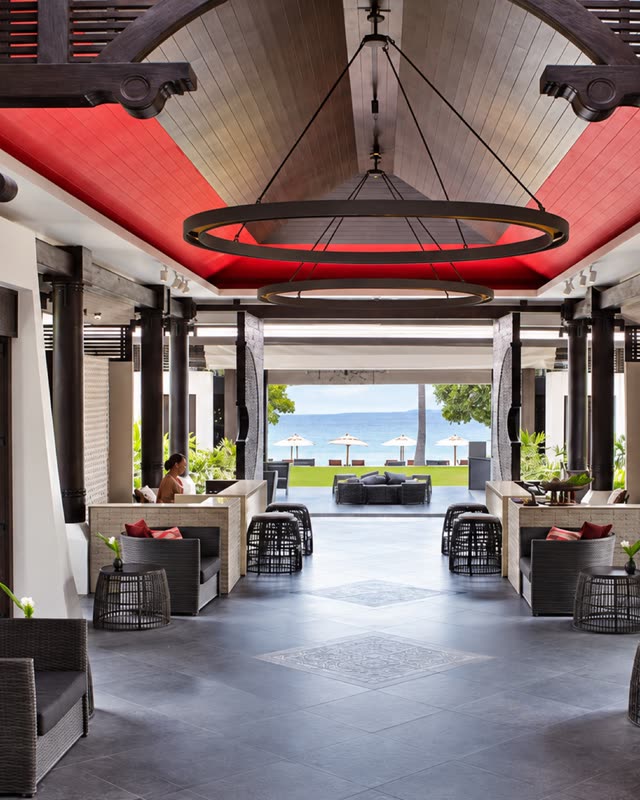 Timber pavilion with a round chandelier and a view through to the sea